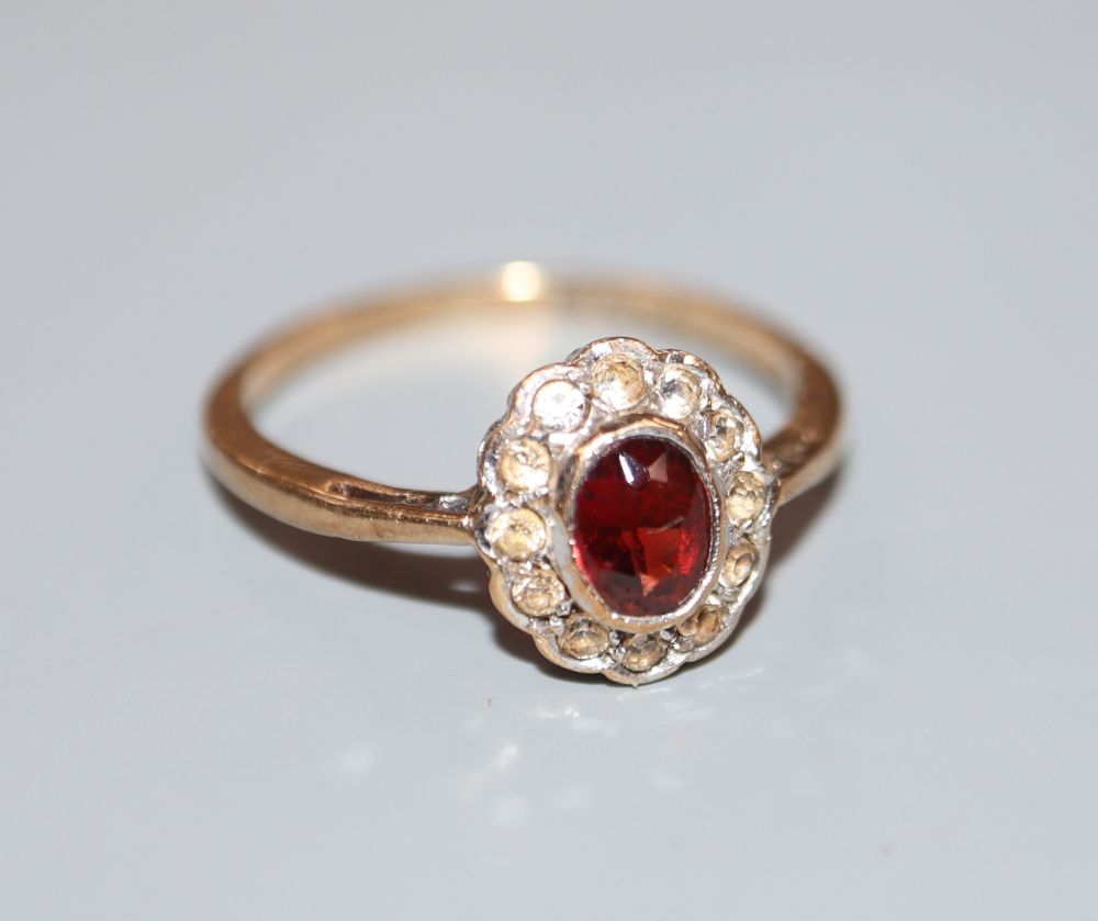 A 1970s 9ct gold, garnet and white sapphire? set oval cluster ring, size L, gross 1.6 grams.